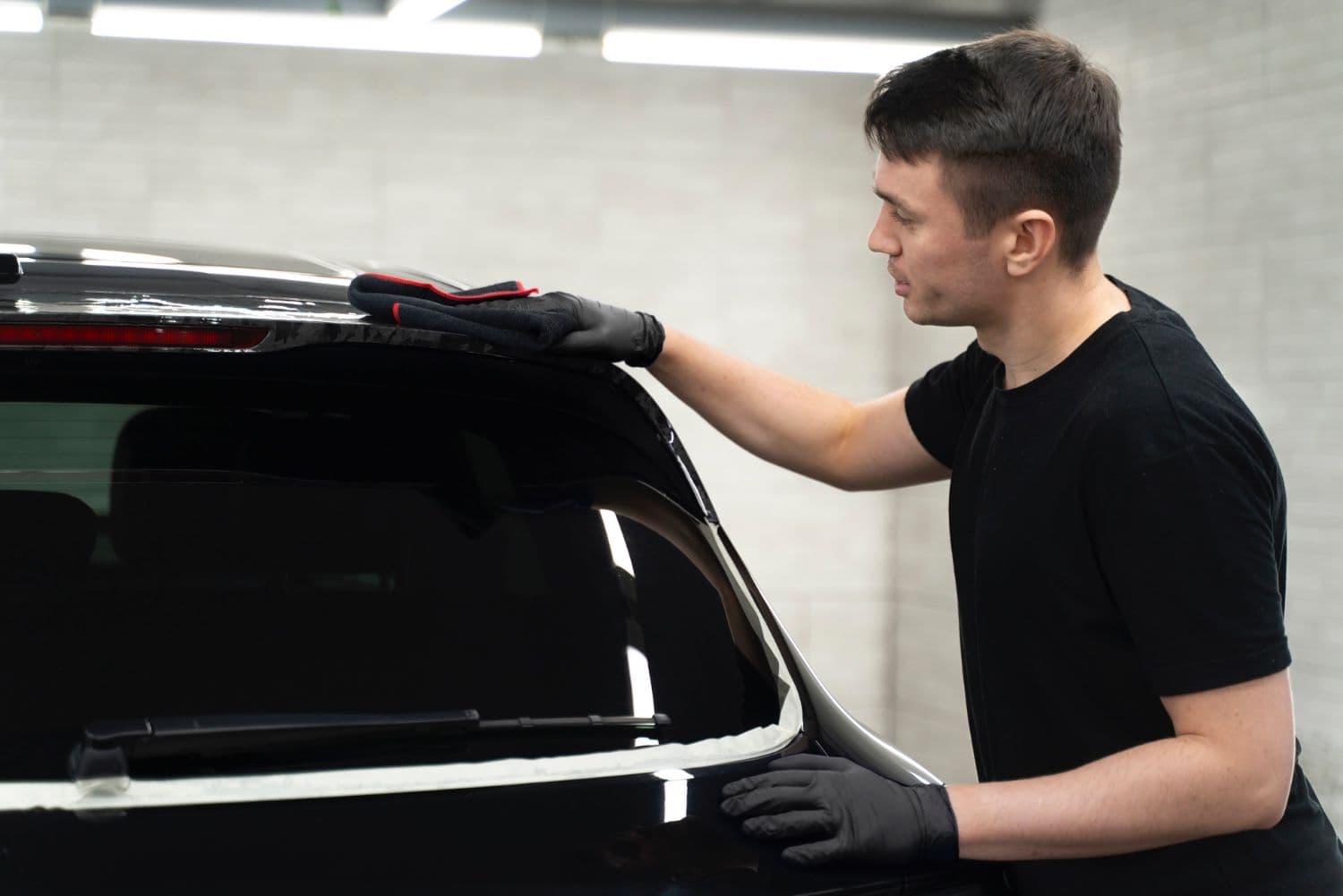 Professional car window tinting being applied at Tint Bros Adelaide workshop