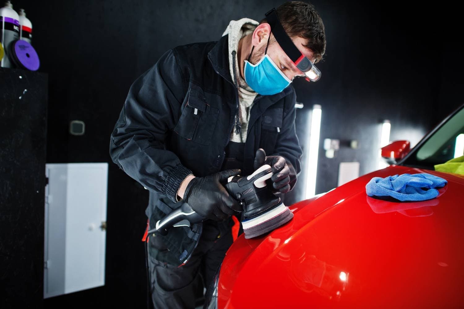 Tint Bros Adelaide technician applying ceramic coating to a car bonnet, with a glossy hydrophobic finish visible