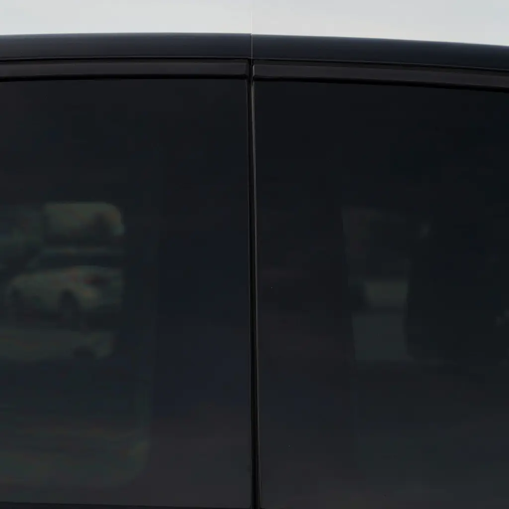 Side by side showing an SUV rear window with factory privacy glass only versus the same window with additional ceramic tint film added at Tint Bros Adelaide